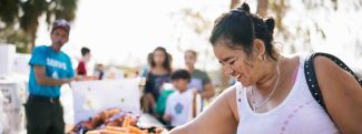 Daisy grabbing produce from a table.